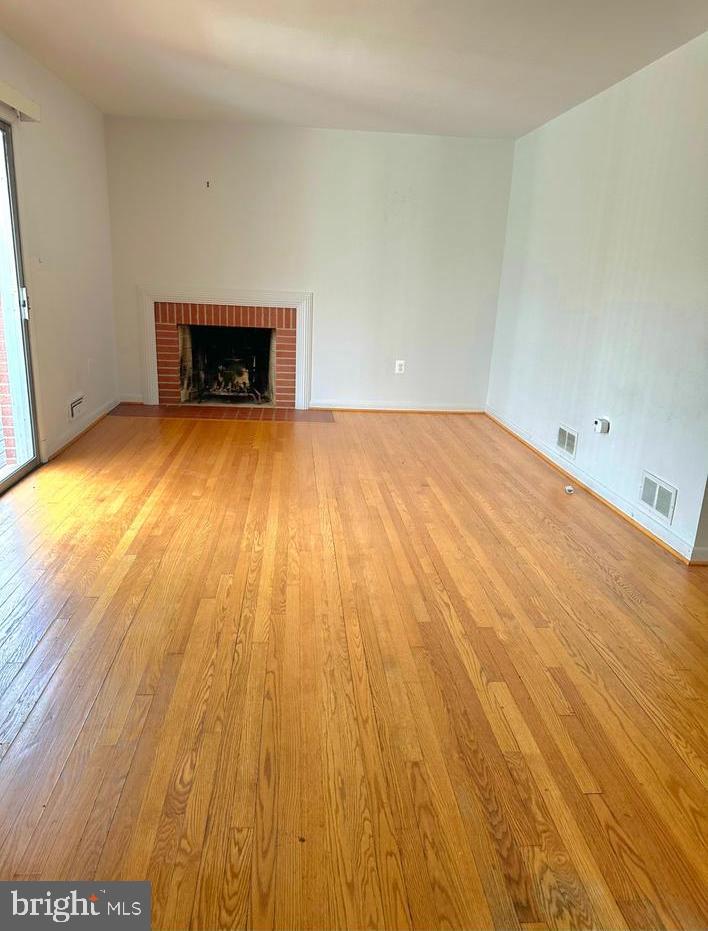 6426 Noble Drive McLean, VA 22101 - Photo 7 of 16 a view of empty room with wooden floor and fireplace