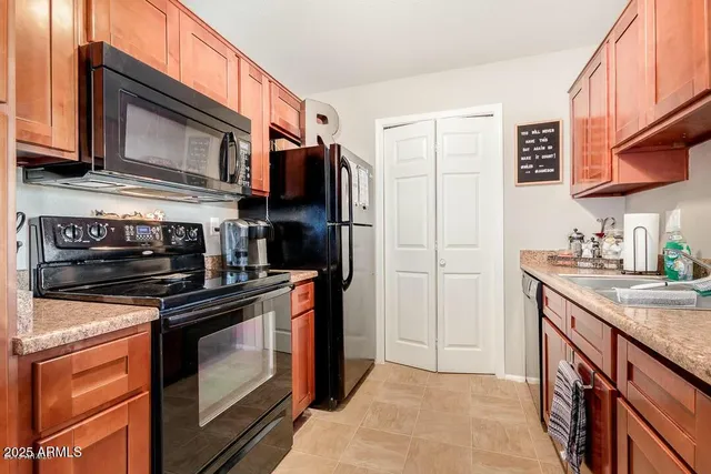 a kitchen with stainless steel appliances granite countertop a stove microwave and refrigerator