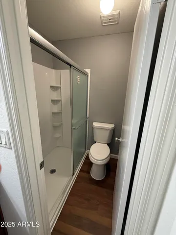 a bathroom with a toilet and a shower