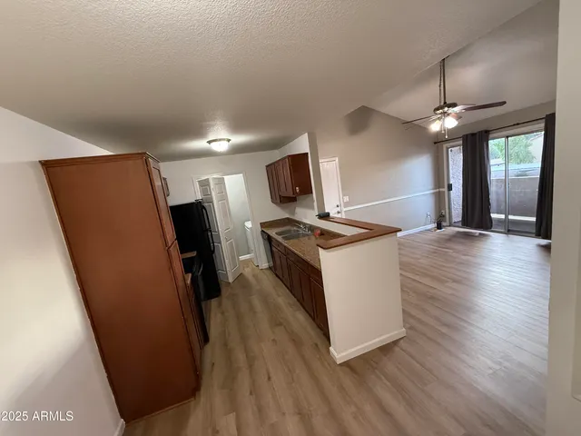 a kitchen with granite countertop a refrigerator and a sink