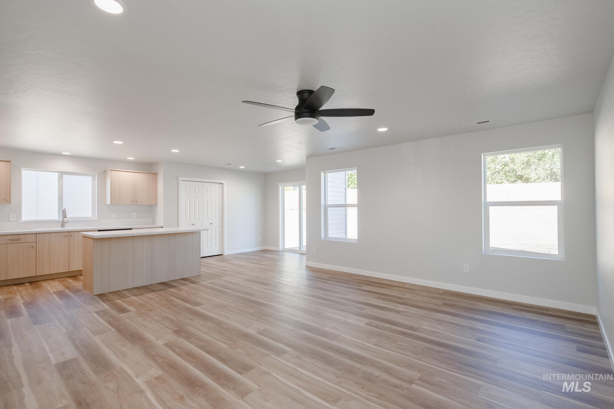 1614 Long Pond Street Middleton, ID 83644 - Photo 28 of 28 Kitchen with light brown cabinetry, light countertops, light wood finished floors, open floor plan, and a center island