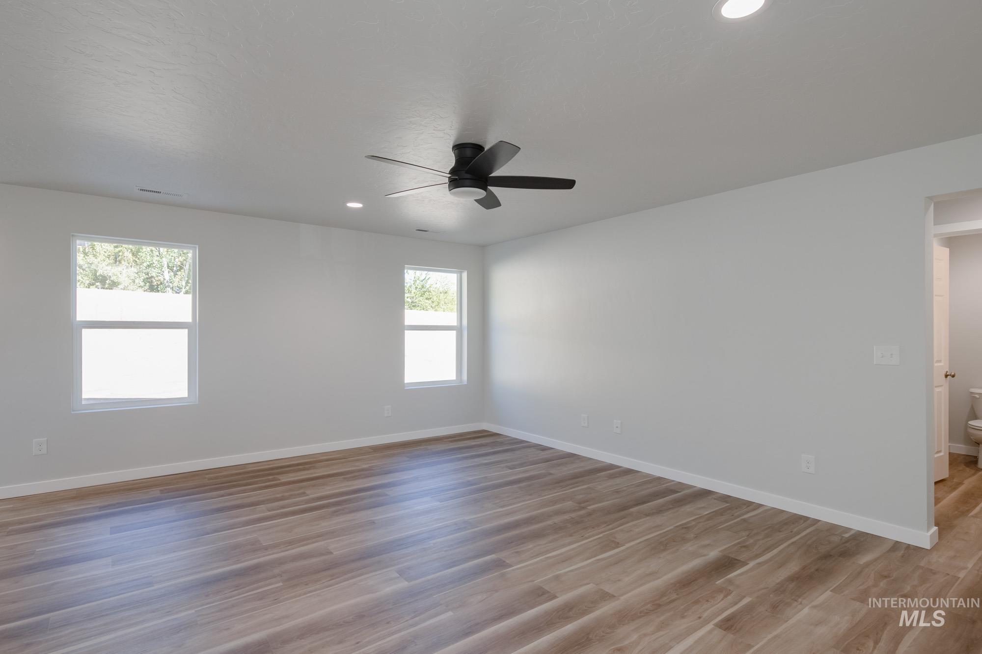 1614 Long Pond Street Middleton, ID 83644 - Photo 11 of 28 Unfurnished room with light wood-type flooring, recessed lighting, and a ceiling fan