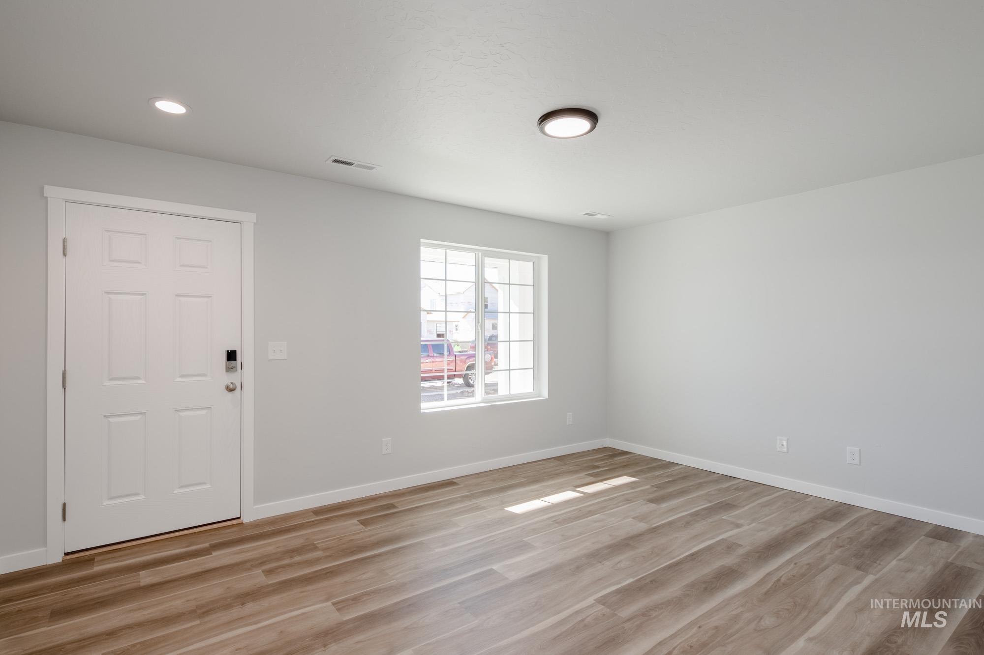 1614 Long Pond Street Middleton, ID 83644 - Photo 14 of 28 Empty room featuring light wood-style flooring and recessed lighting