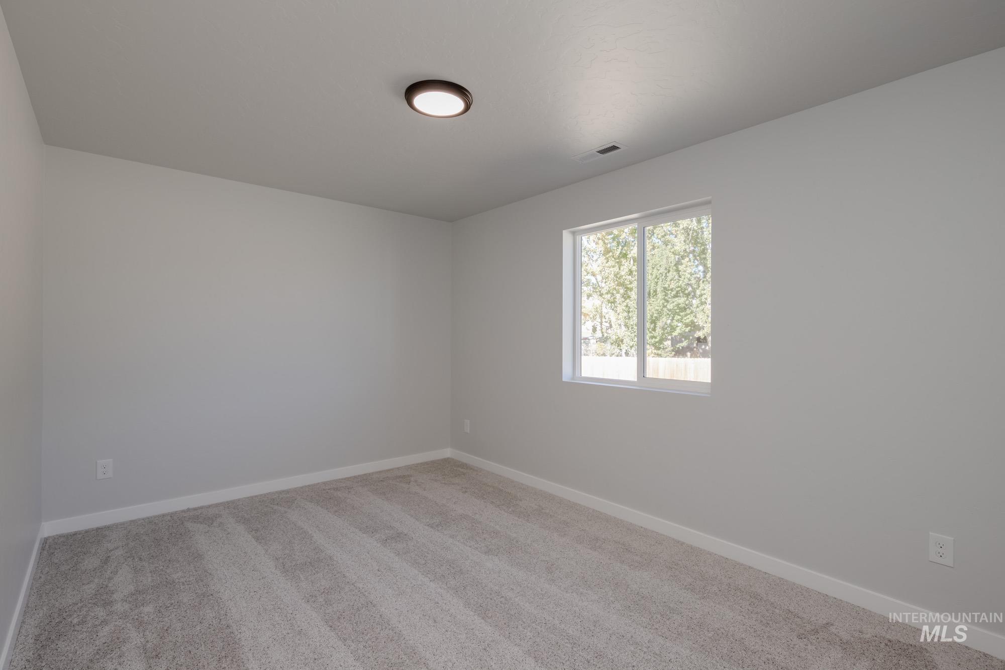 1614 Long Pond Street Middleton, ID 83644 - Photo 17 of 28 Spare room featuring light carpet and baseboards