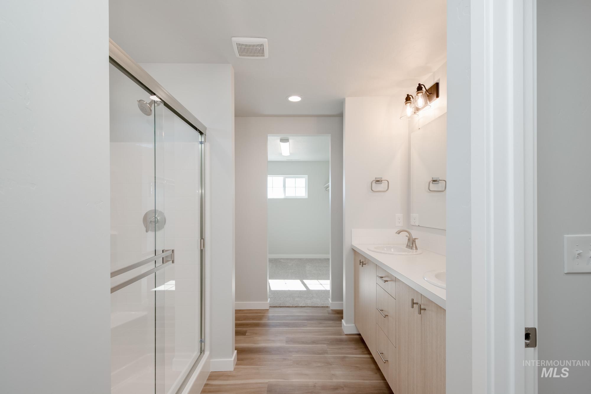 1614 Long Pond Street Middleton, ID 83644 - Photo 20 of 28 Bathroom featuring double vanity, light wood-style flooring, a shower stall, and recessed lighting