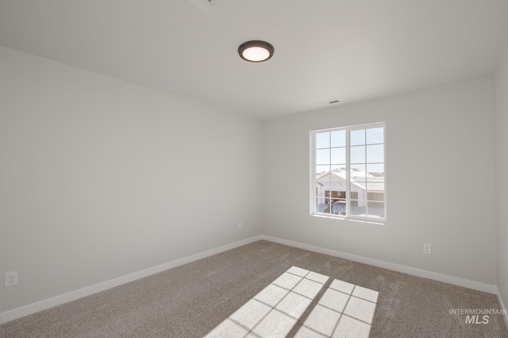 1614 Long Pond Street Middleton, ID 83644 - Photo 24 of 28 Carpeted spare room featuring baseboards