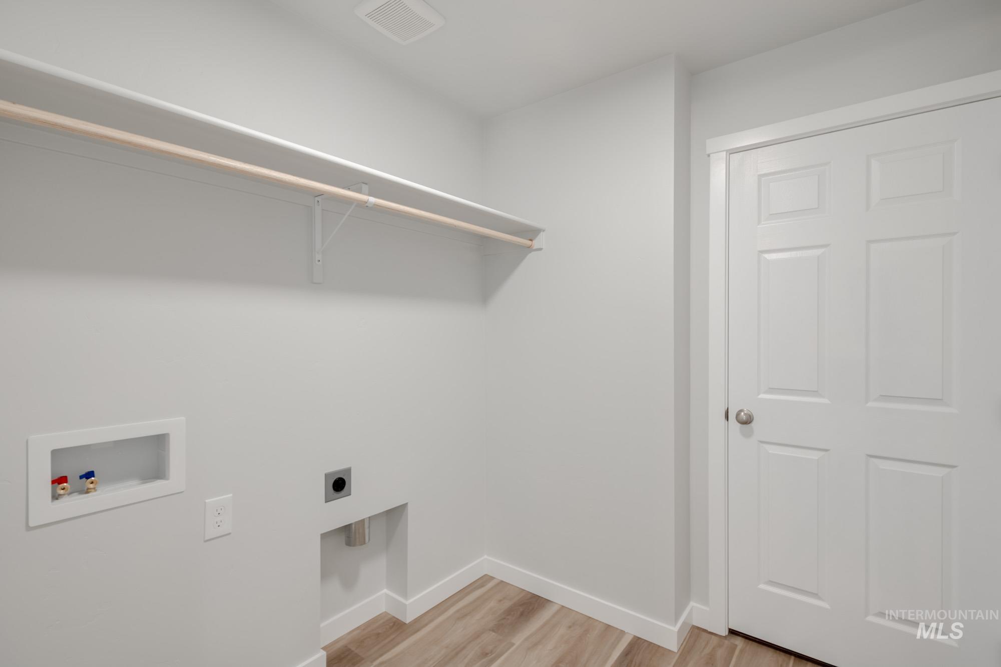 1614 Long Pond Street Middleton, ID 83644 - Photo 26 of 28 Laundry area featuring light wood-style flooring, hookup for a washing machine, and hookup for an electric dryer