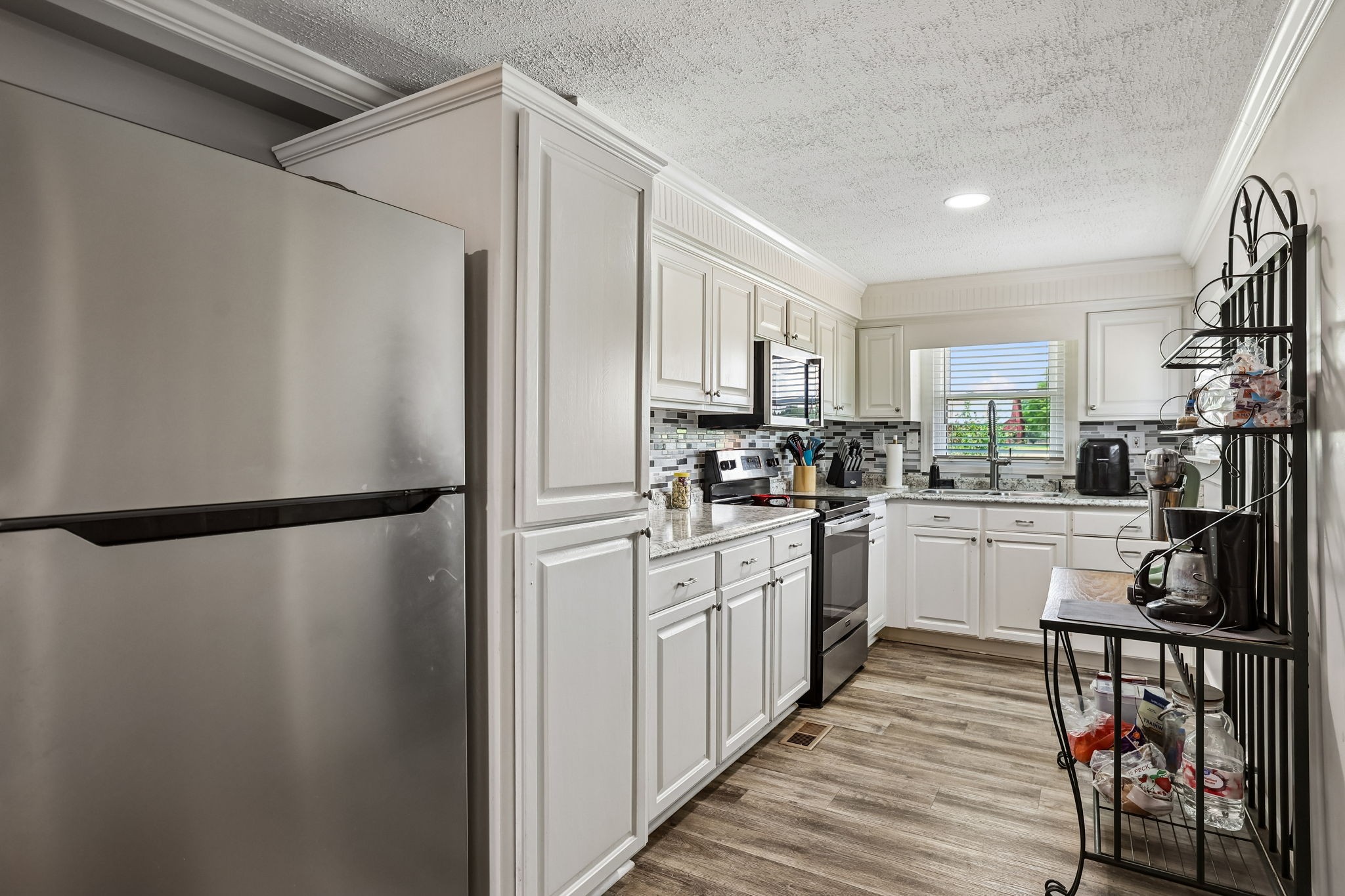 1466 Bible Crossing Road Winchester, TN 37398 - Photo 20 of 42 a kitchen with a refrigerator a sink and cabinets