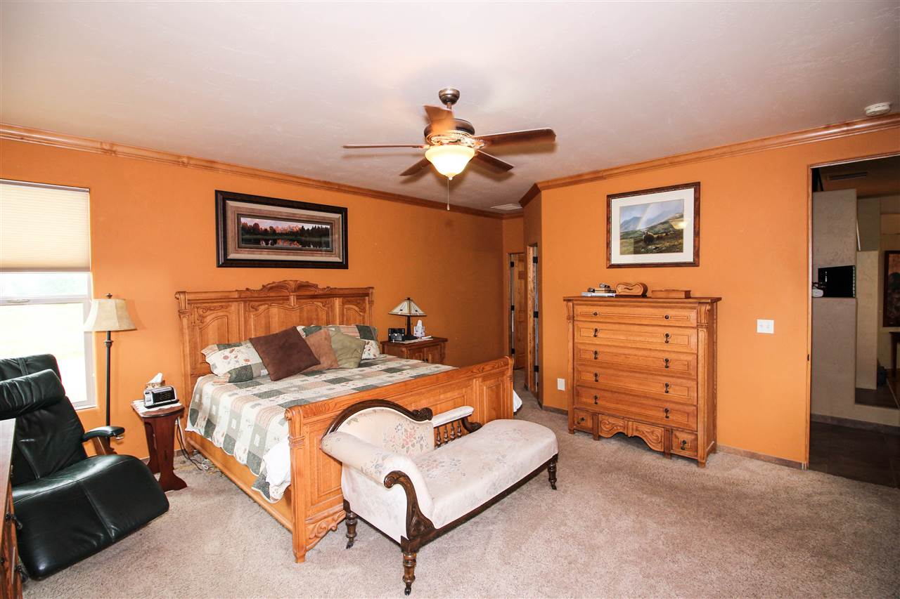 1114 22 Road Grand Junction, CO 81505 - Photo 11 of 26 a bed room with a bed and a ceiling fan