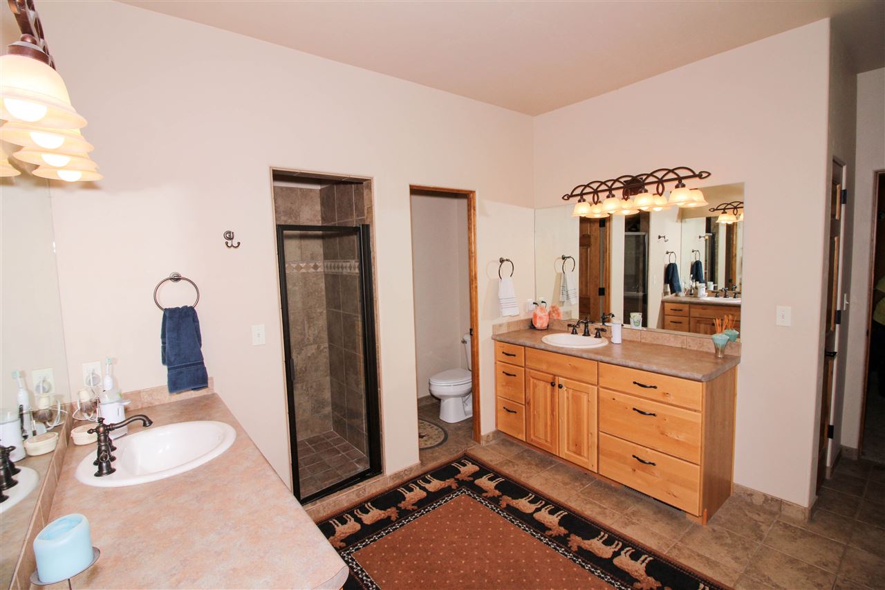 1114 22 Road Grand Junction, CO 81505 - Photo 13 of 26 a bathroom with a double vanity sink and mirror