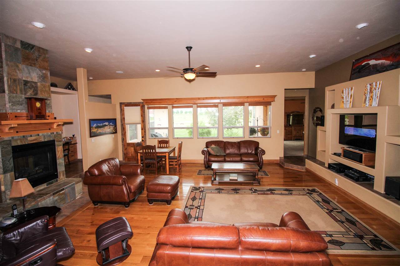 1114 22 Road Grand Junction, CO 81505 - Photo 2 of 26 a living room with furniture fireplace and flat screen tv