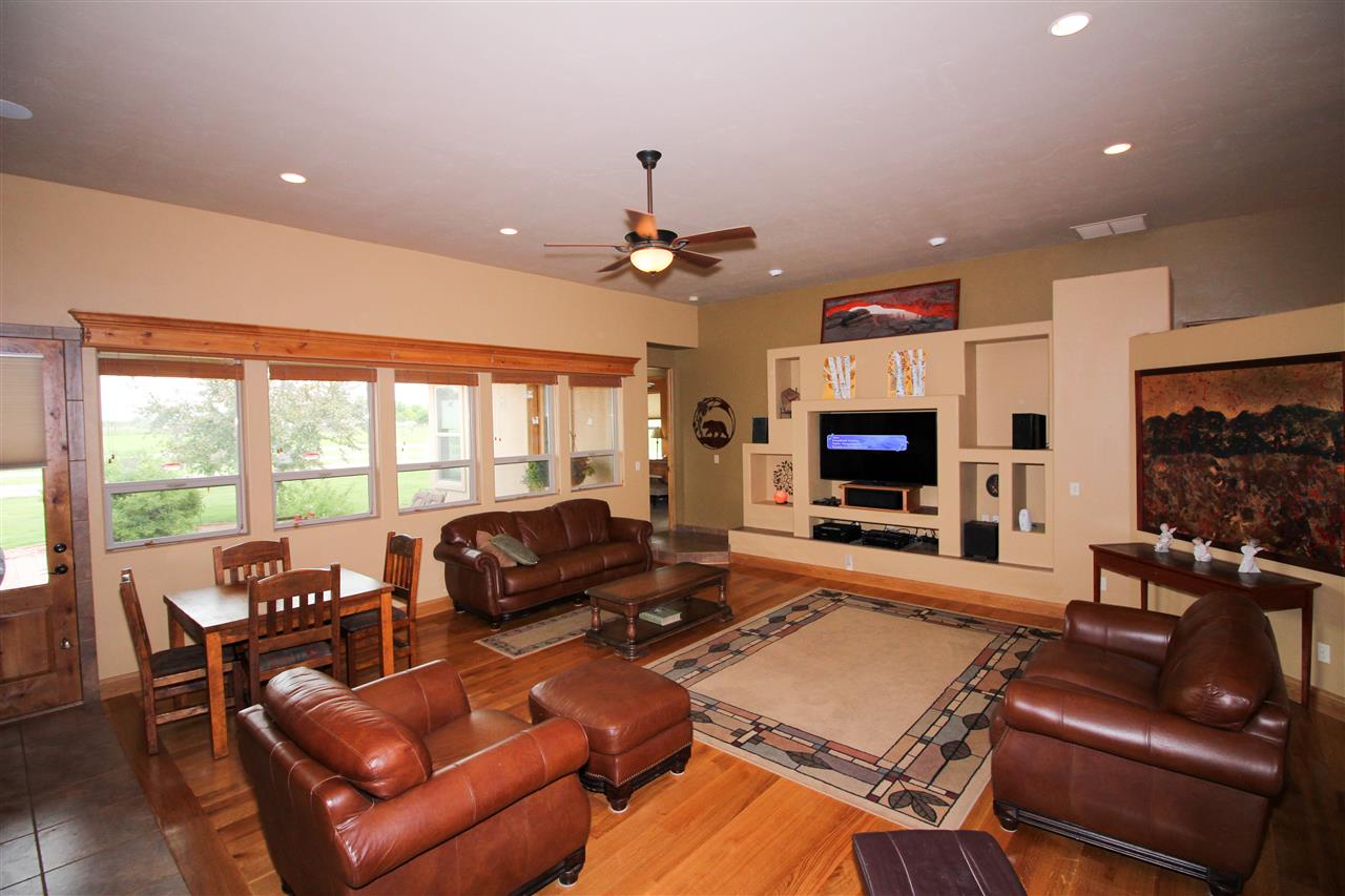 1114 22 Road Grand Junction, CO 81505 - Photo 3 of 26 a living room with furniture a flat screen tv and a large window