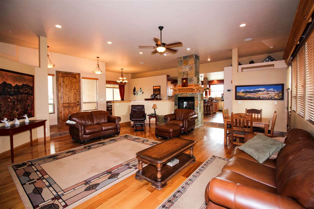 1114 22 Road Grand Junction, CO 81505 - Photo 4 of 26 a living room with furniture kitchen view and a chandelier