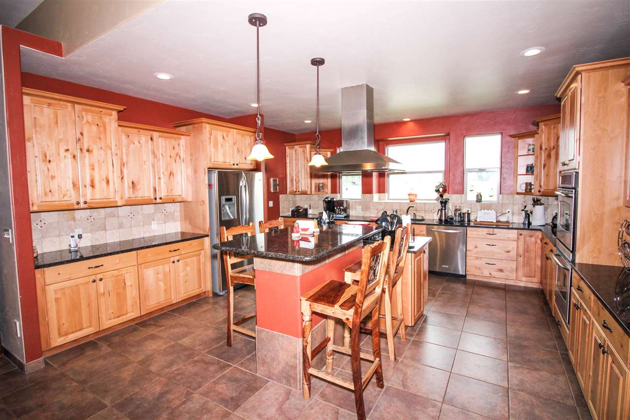 1114 22 Road Grand Junction, CO 81505 - Photo 5 of 26 a open kitchen with stainless steel appliances granite countertop a stove and refrigerator