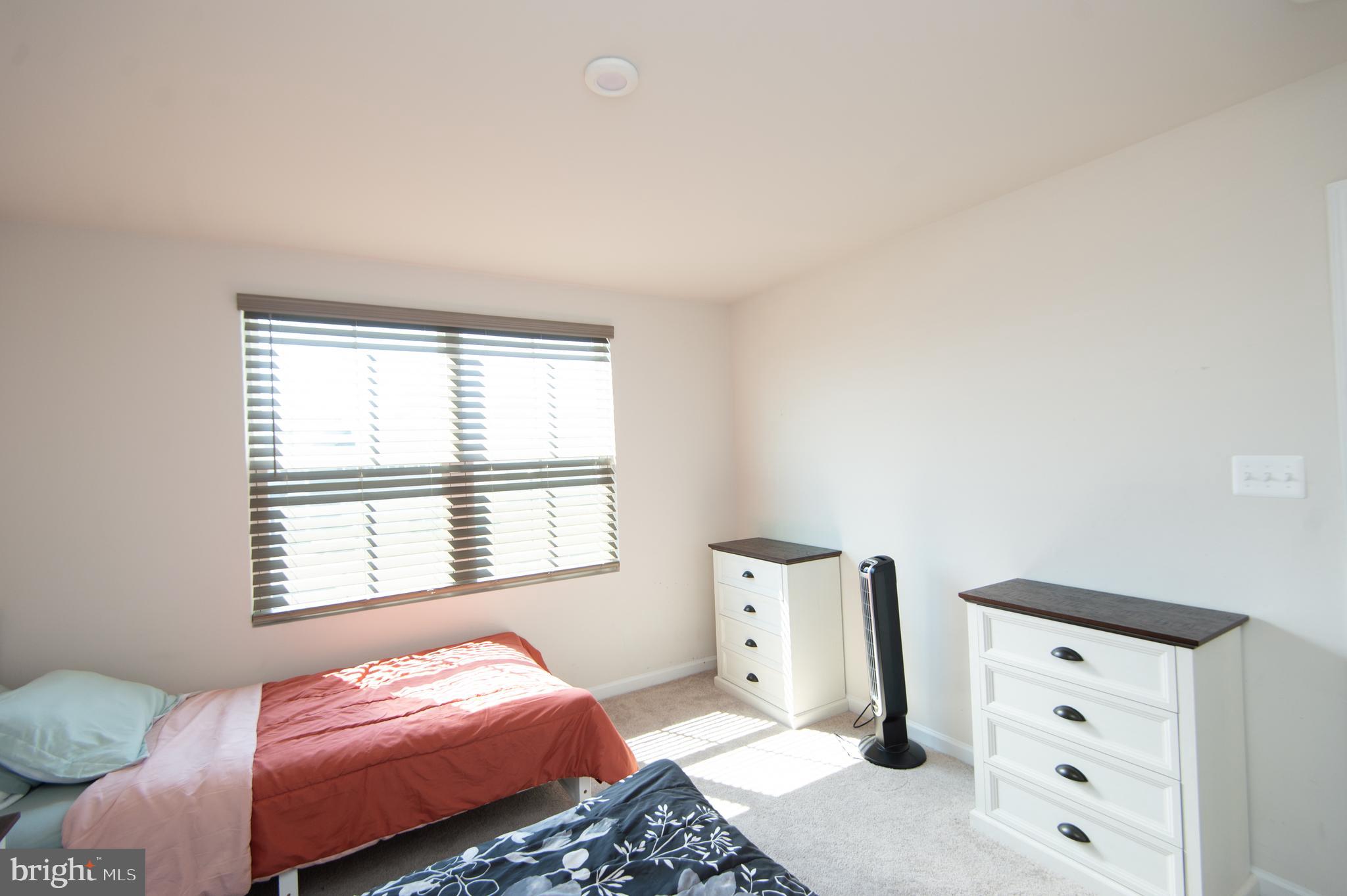 112 Mariners Way Cambridge, MD 21613 - Photo 16 of 29 a bedroom with a bed and a window