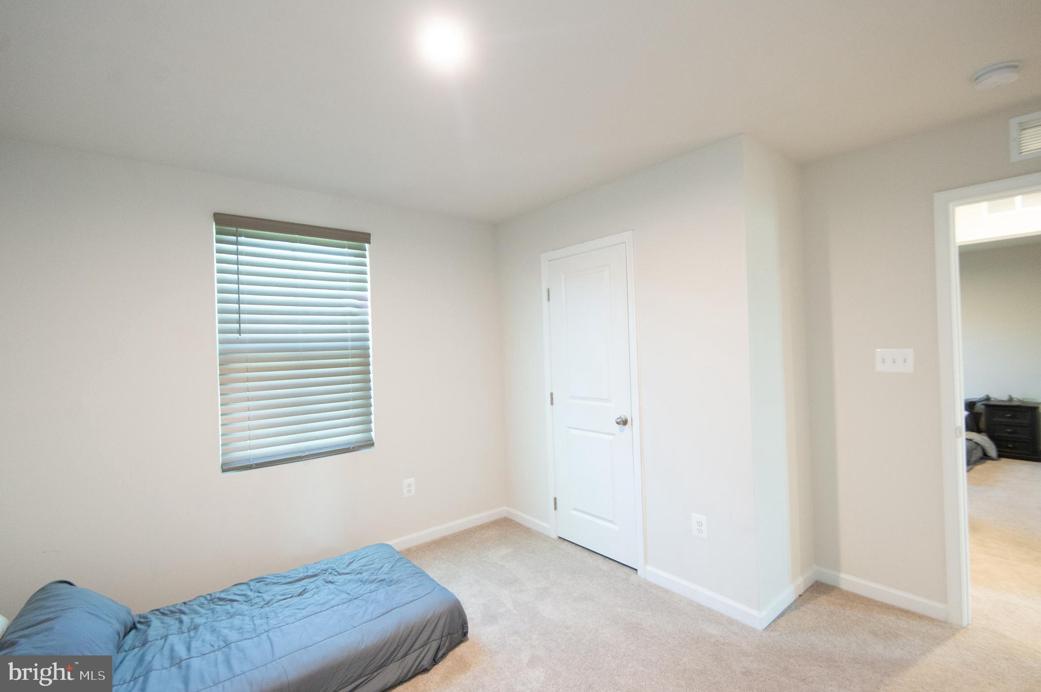 112 Mariners Way Cambridge, MD 21613 - Photo 18 of 29 a bedroom with a bed and a window