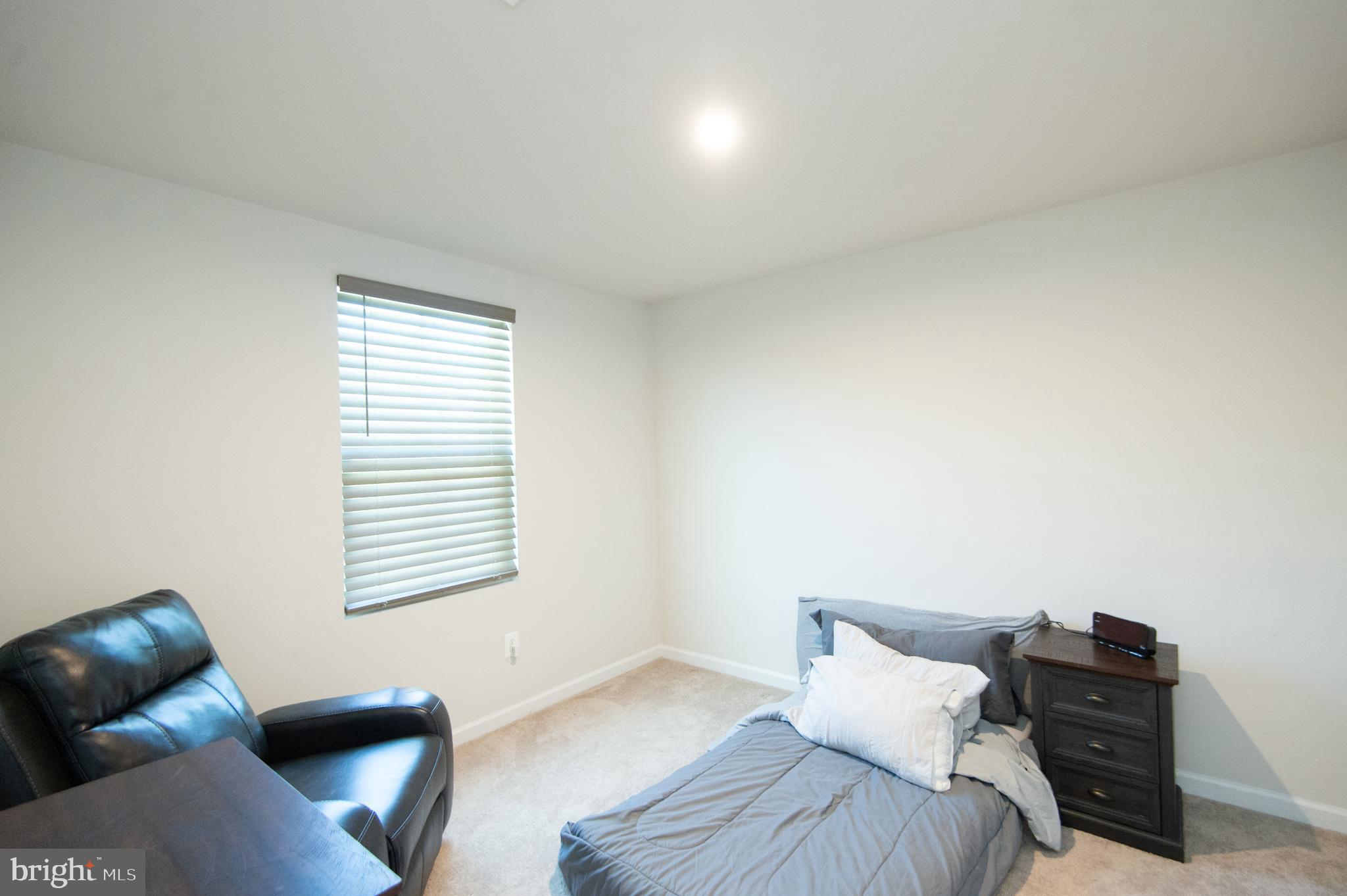 112 Mariners Way Cambridge, MD 21613 - Photo 20 of 29 a bedroom with a bed and a chair