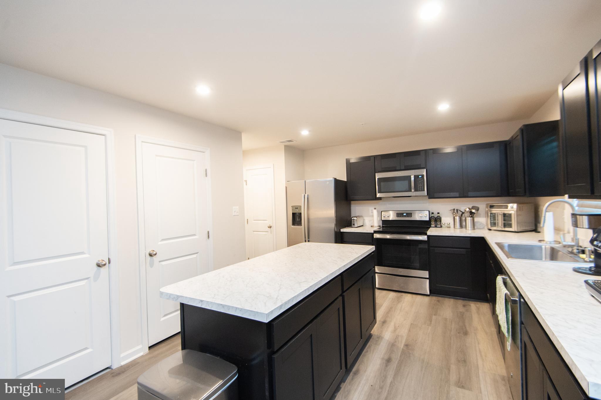 112 Mariners Way Cambridge, MD 21613 - Photo 6 of 29 a kitchen with stainless steel appliances a sink stove and refrigerator