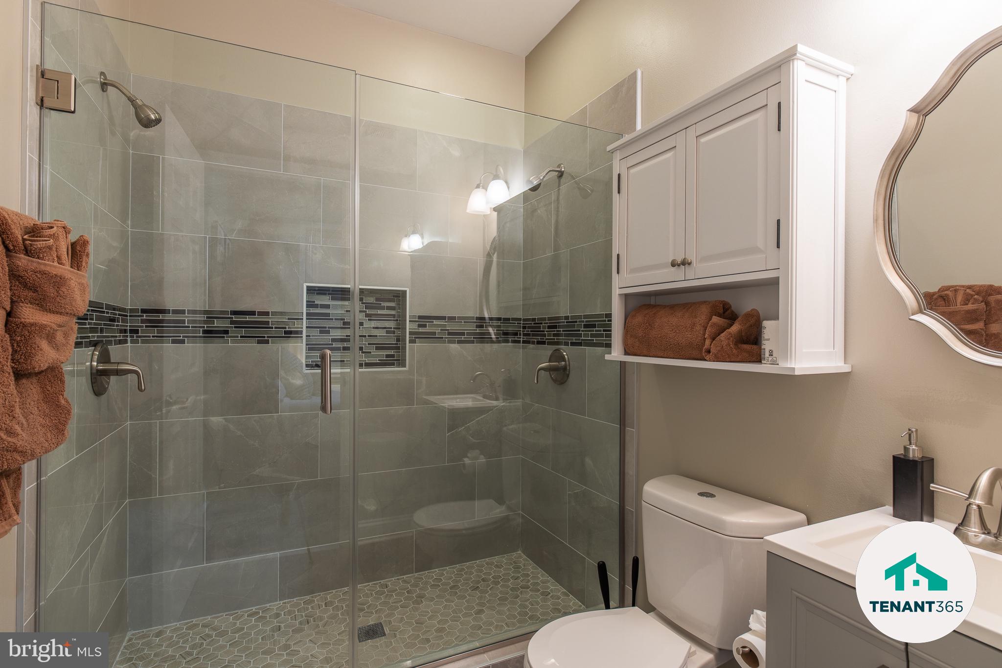 3221 Noble Street, Unit 4 Baltimore, MD 21224 - Photo 16 of 18 Modern glass shower with elegant tiles.