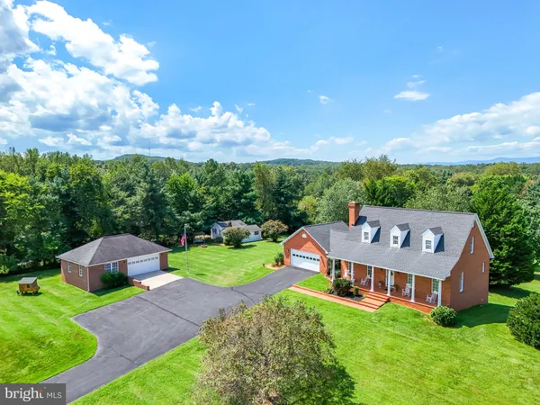 an aerial view of a house with big yard