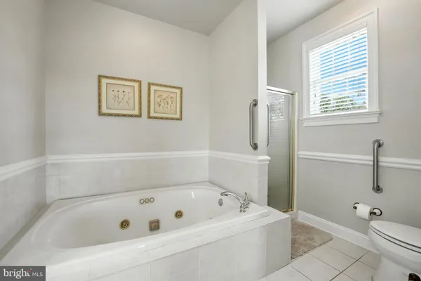 a view of a hallway with wooden floor and stairs