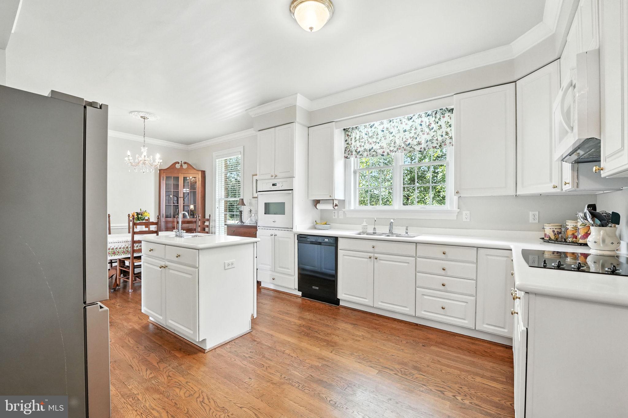 12564 Eggbornsville Road Culpeper, VA 22701 - Photo 30 of 62 a kitchen with white cabinets and white appliances