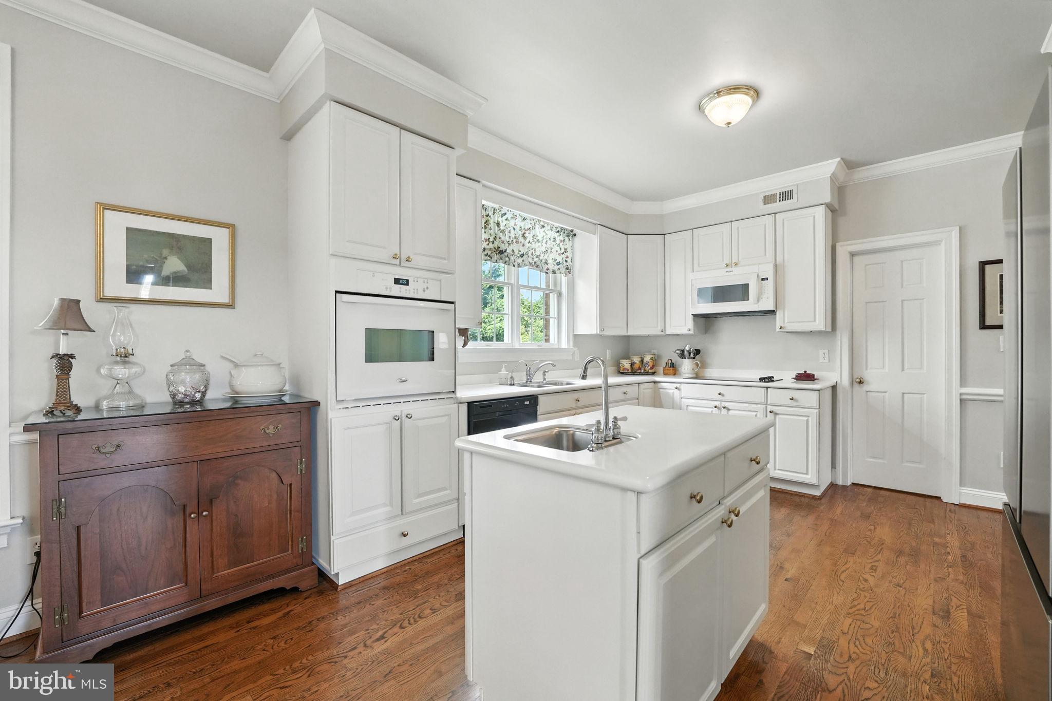 12564 Eggbornsville Road Culpeper, VA 22701 - Photo 33 of 62 a kitchen with white cabinets and white appliances