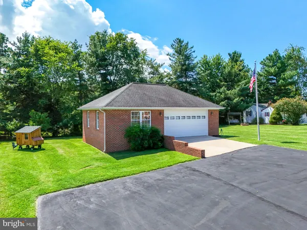 a view of a house with a yard and a fountain