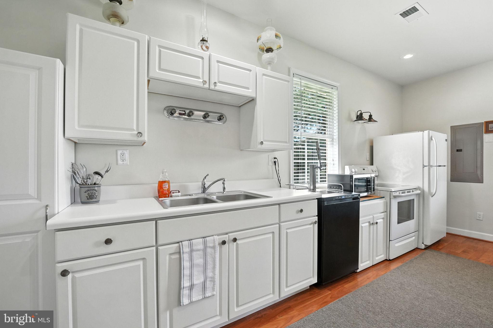 12564 Eggbornsville Road Culpeper, VA 22701 - Photo 49 of 62 a kitchen with stainless steel appliances granite countertop a sink stove refrigerator and cabinets