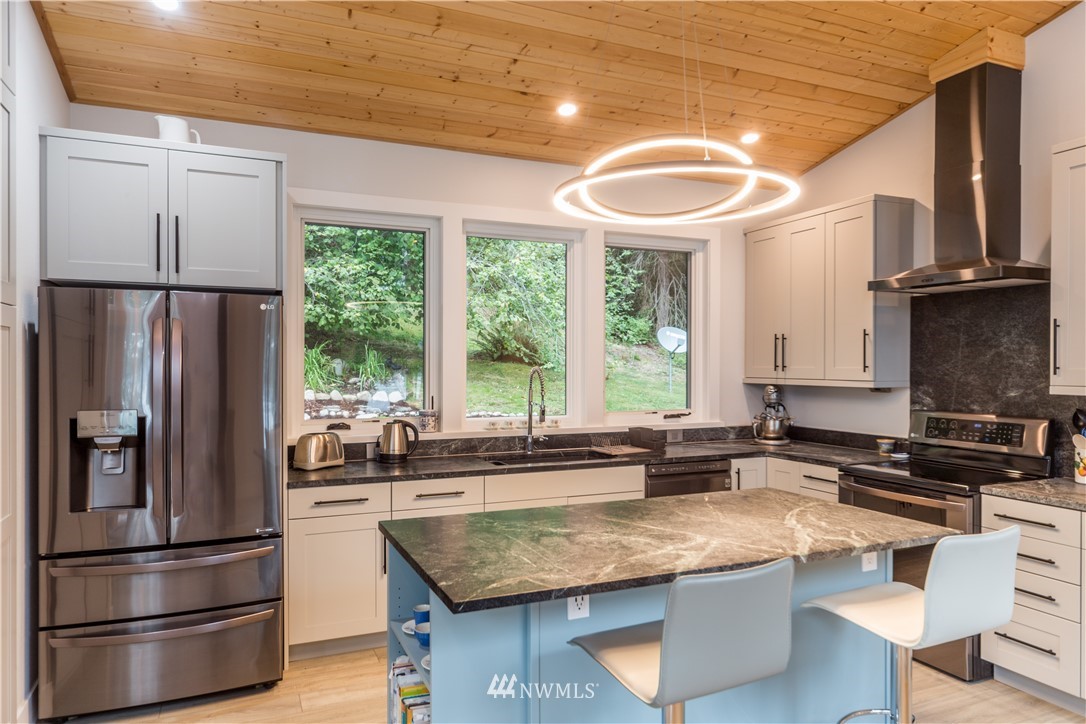 884 McDonald Road, Unit EXT Quilcene, WA 98376 - Photo 11 of 38 a kitchen with stainless steel appliances granite countertop a sink stove and refrigerator