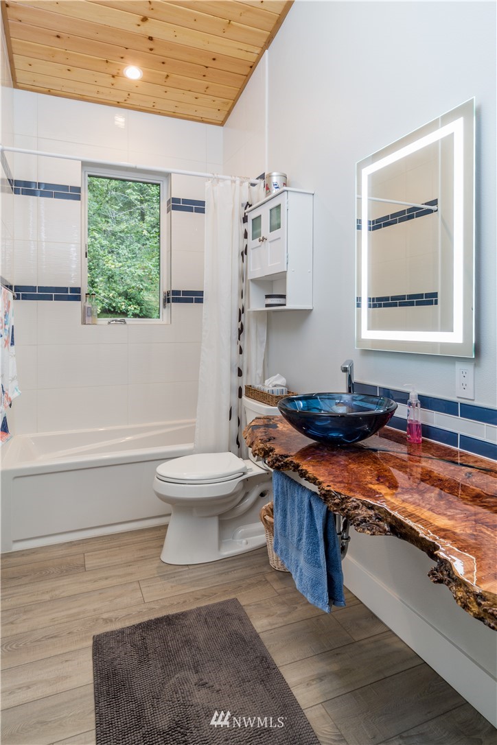 884 McDonald Road, Unit EXT Quilcene, WA 98376 - Photo 21 of 38 a bathroom with a toilet sink and mirror