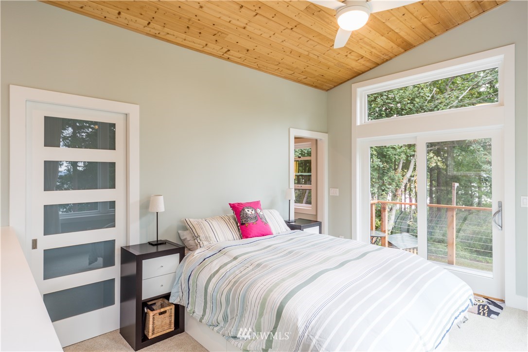 884 McDonald Road, Unit EXT Quilcene, WA 98376 - Photo 23 of 38 a bedroom with a large bed and a large window