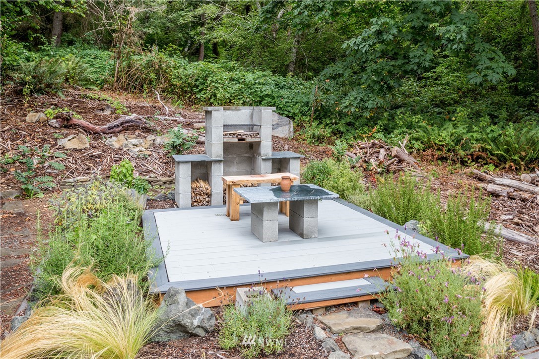 884 McDonald Road, Unit EXT Quilcene, WA 98376 - Photo 30 of 38 a roof deck with table and chairs plants and trees