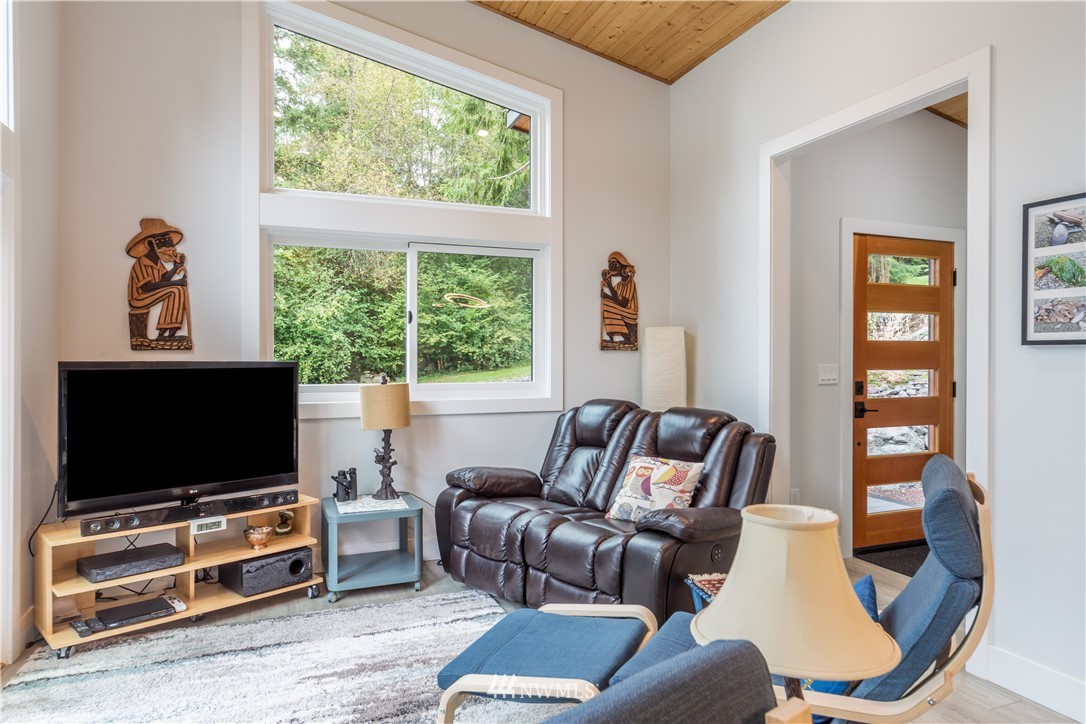 884 McDonald Road, Unit EXT Quilcene, WA 98376 - Photo 6 of 38 a living room with furniture and a flat screen tv