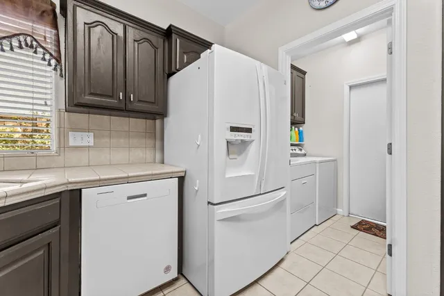 a white refrigerator freezer sitting inside of a kitchen