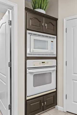 a stove top oven sitting inside of a kitchen