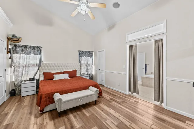 a bedroom with a bed and a chandelier