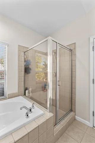 a bathroom with a bathtub and a shower