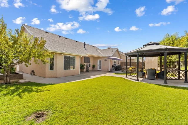 a view of a house with swimming pool and sitting area