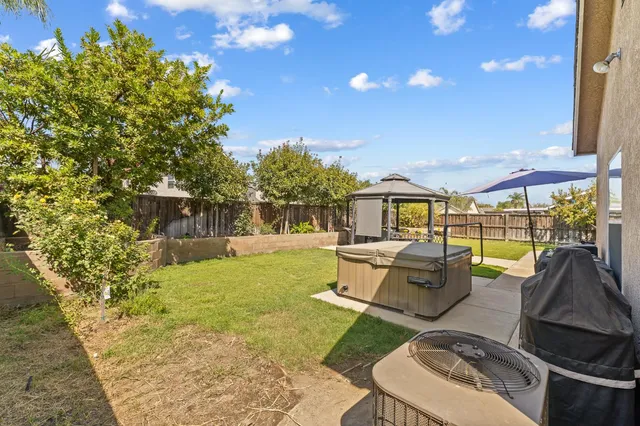 a view of a patio with couches table and chairs and potted plants