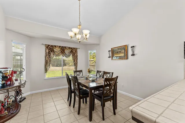 a view of a dining room with furniture and a chandelier