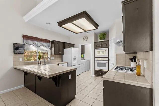a kitchen with a stove sink and a refrigerator
