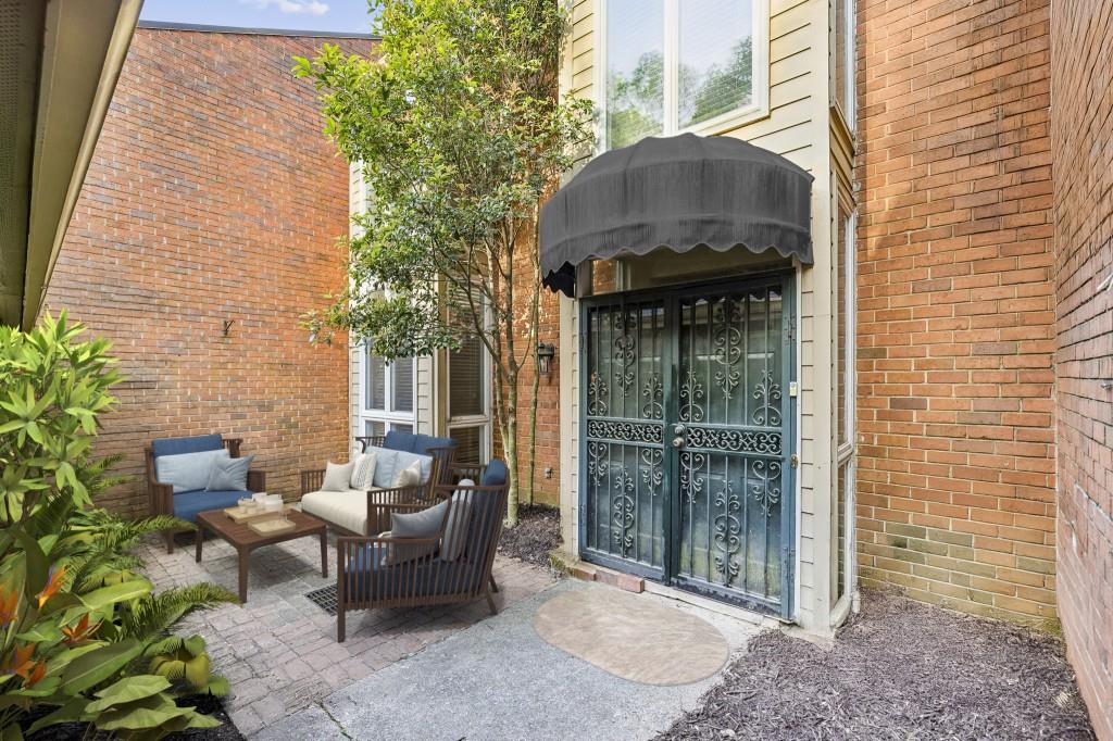 a brick house with outdoor seating space