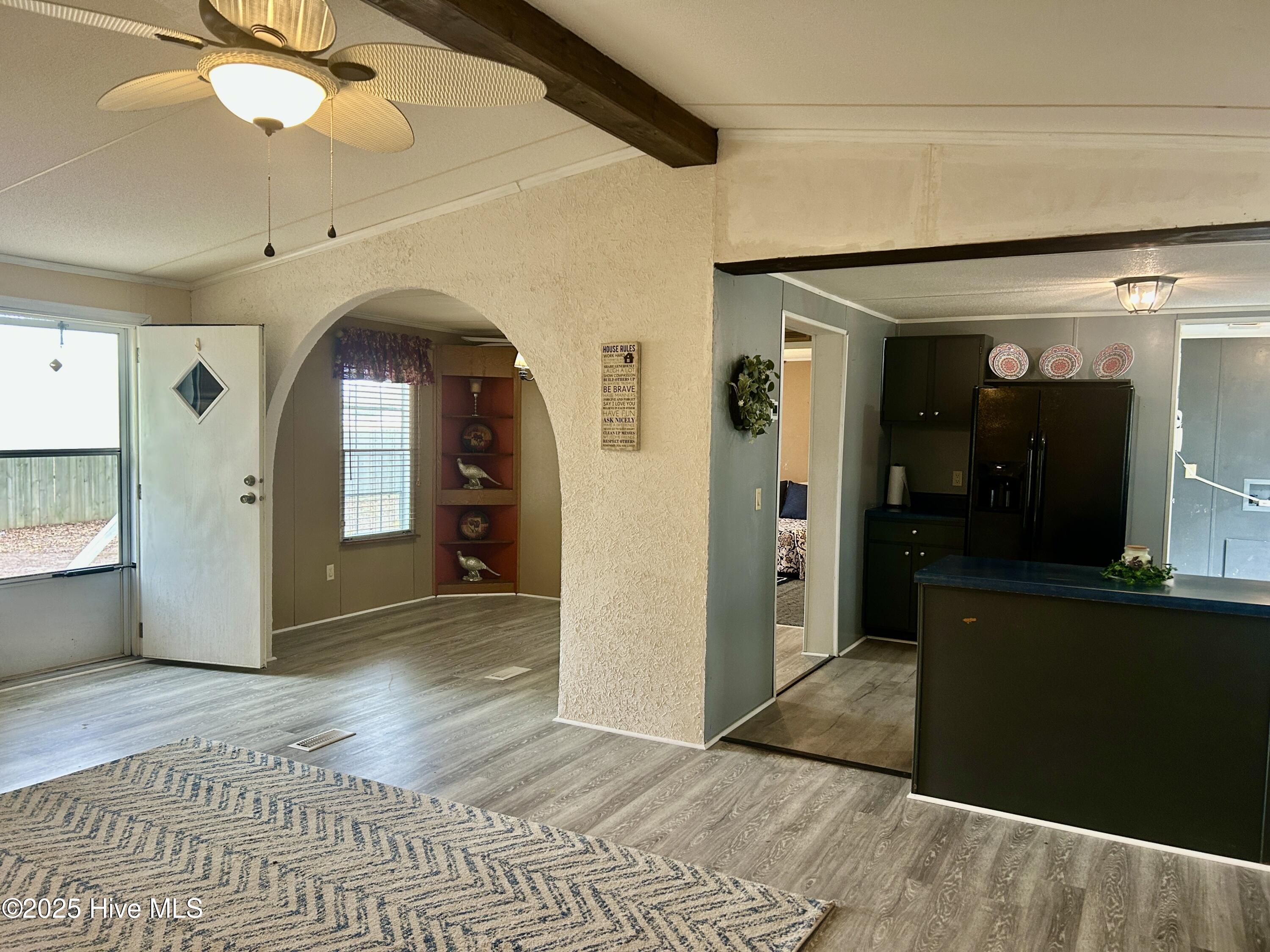 101 Dudley Farm Road Scotland Neck, NC 27874 - Photo 9 of 45 living room looking from fireplace to front door and into the kitchen