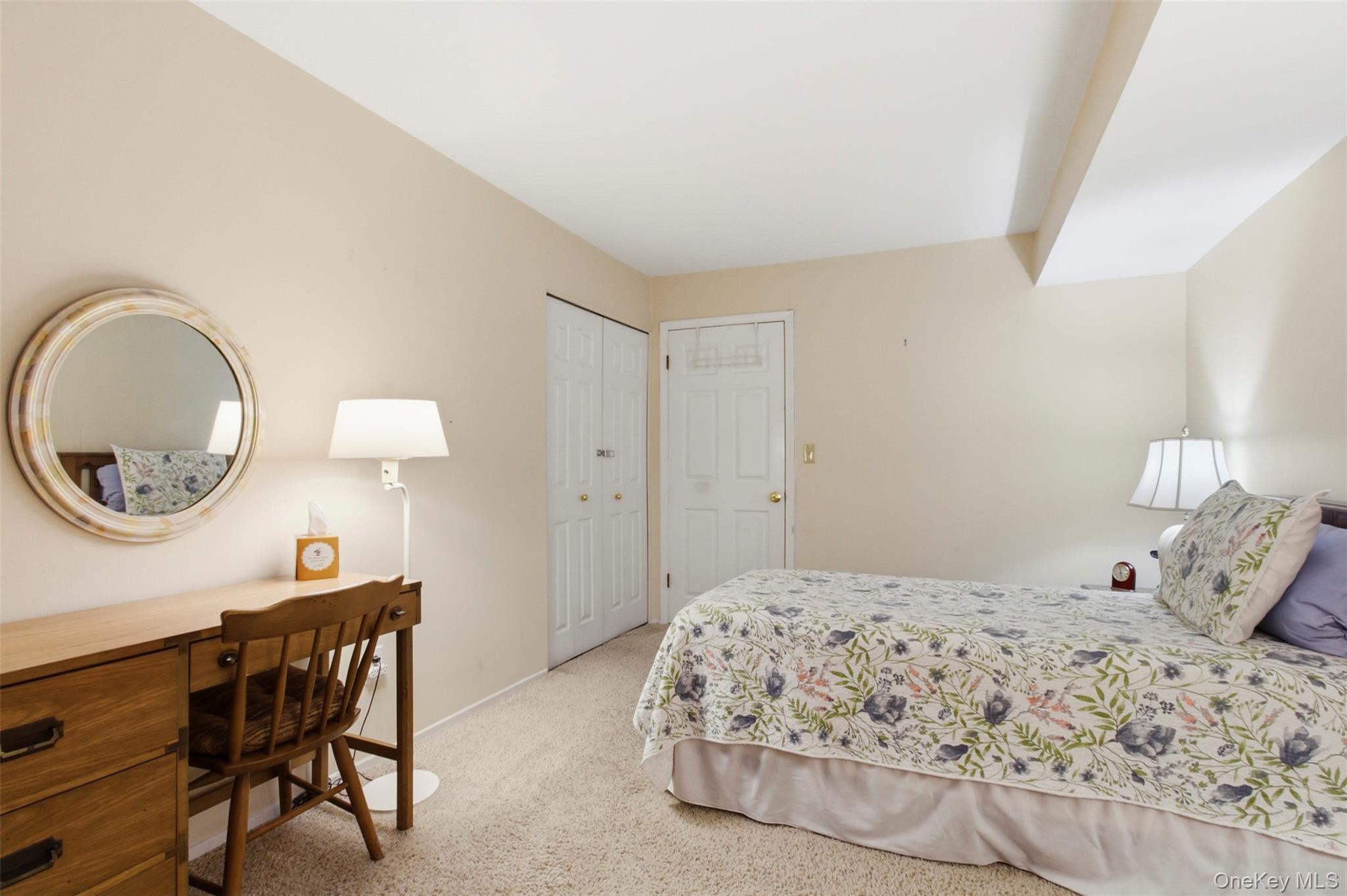 100 Gateway Road, Unit 192N Yonkers, NY 10703 - Photo 12 of 16 a bedroom with a bed and a a mirror on dresser