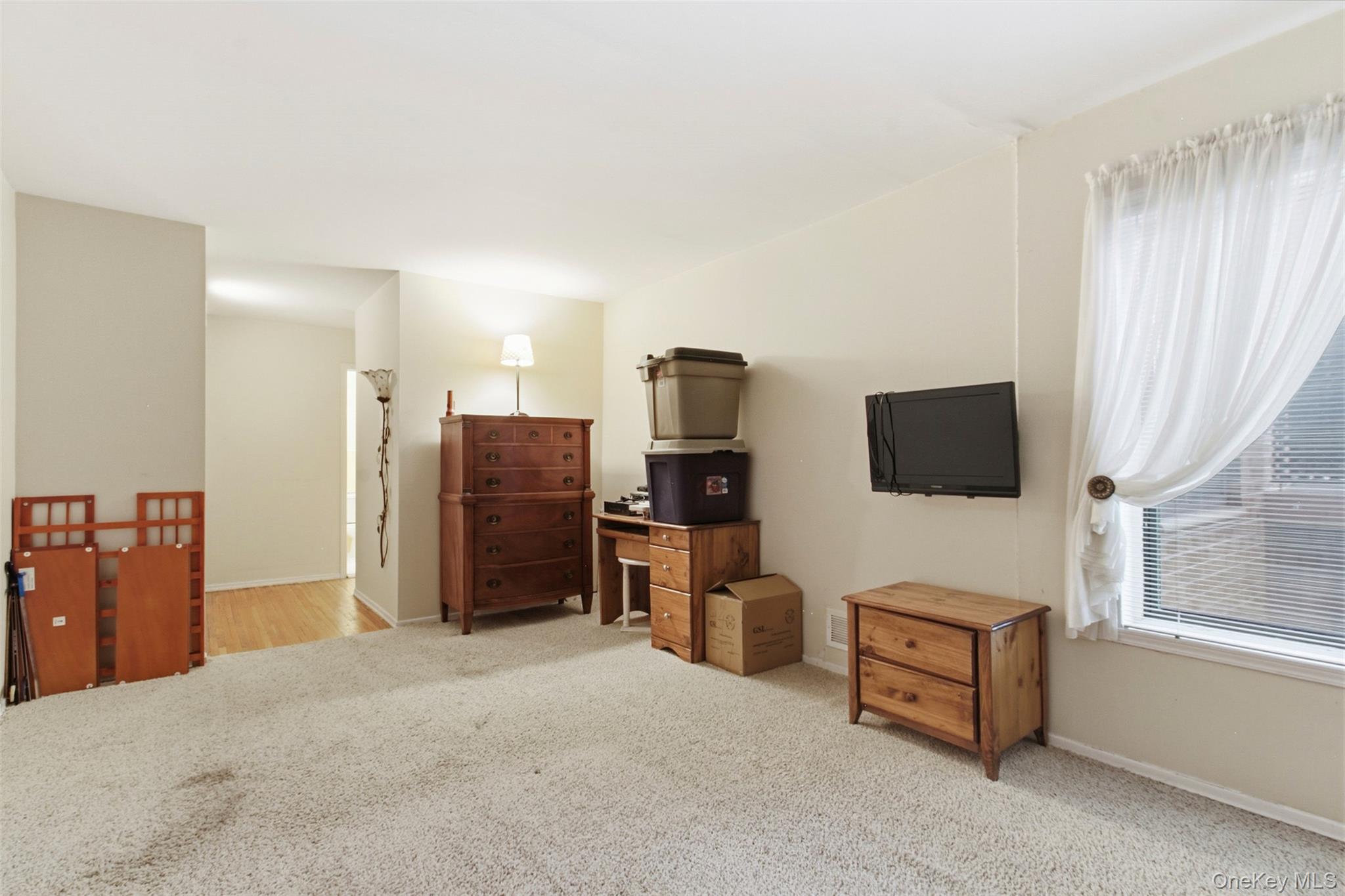 100 Gateway Road, Unit 192N Yonkers, NY 10703 - Photo 14 of 16 a view of a livingroom with furniture and a flat screen tv