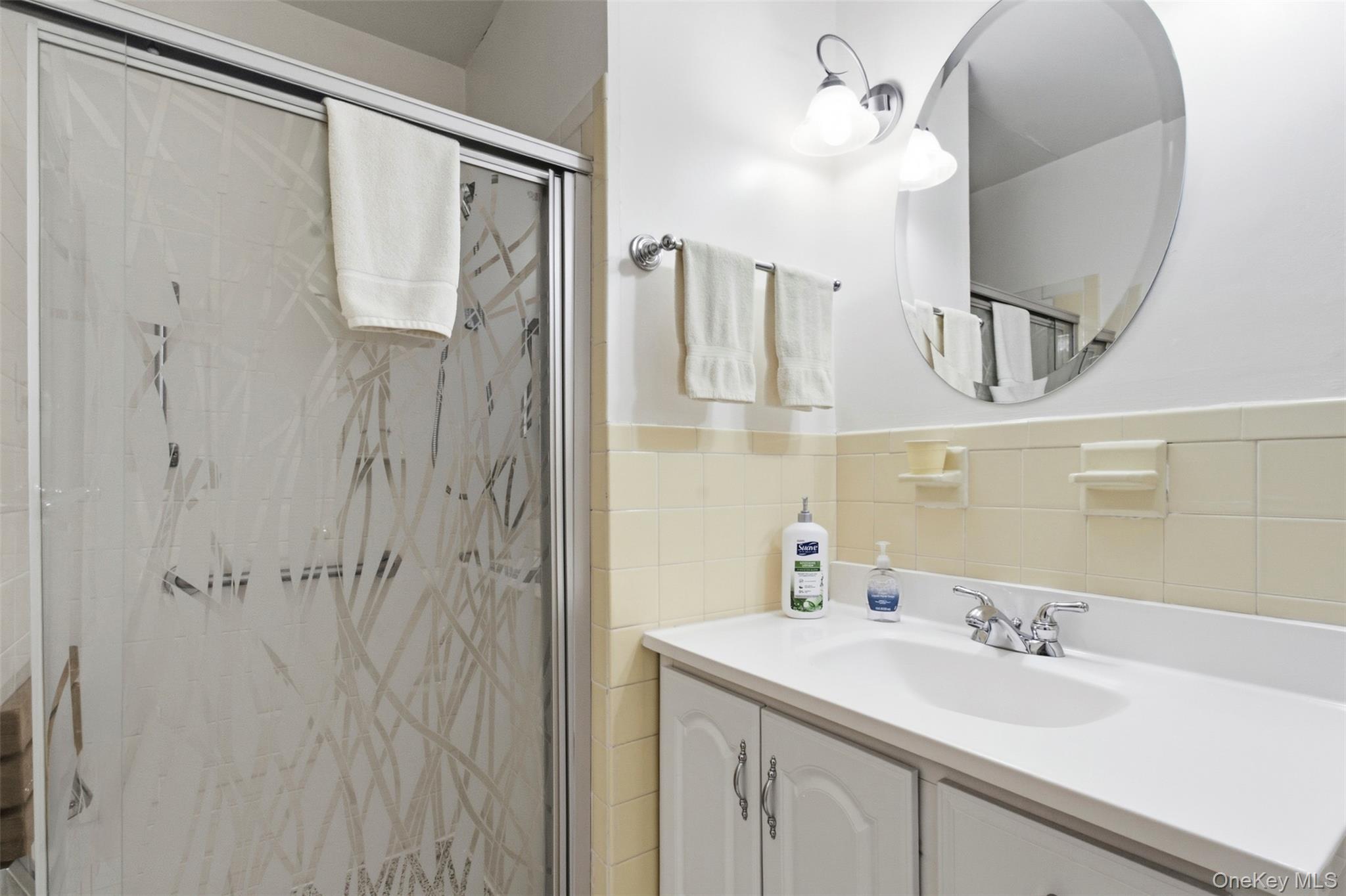 100 Gateway Road, Unit 192N Yonkers, NY 10703 - Photo 15 of 16 a bathroom with a sink vanity granite and a mirror