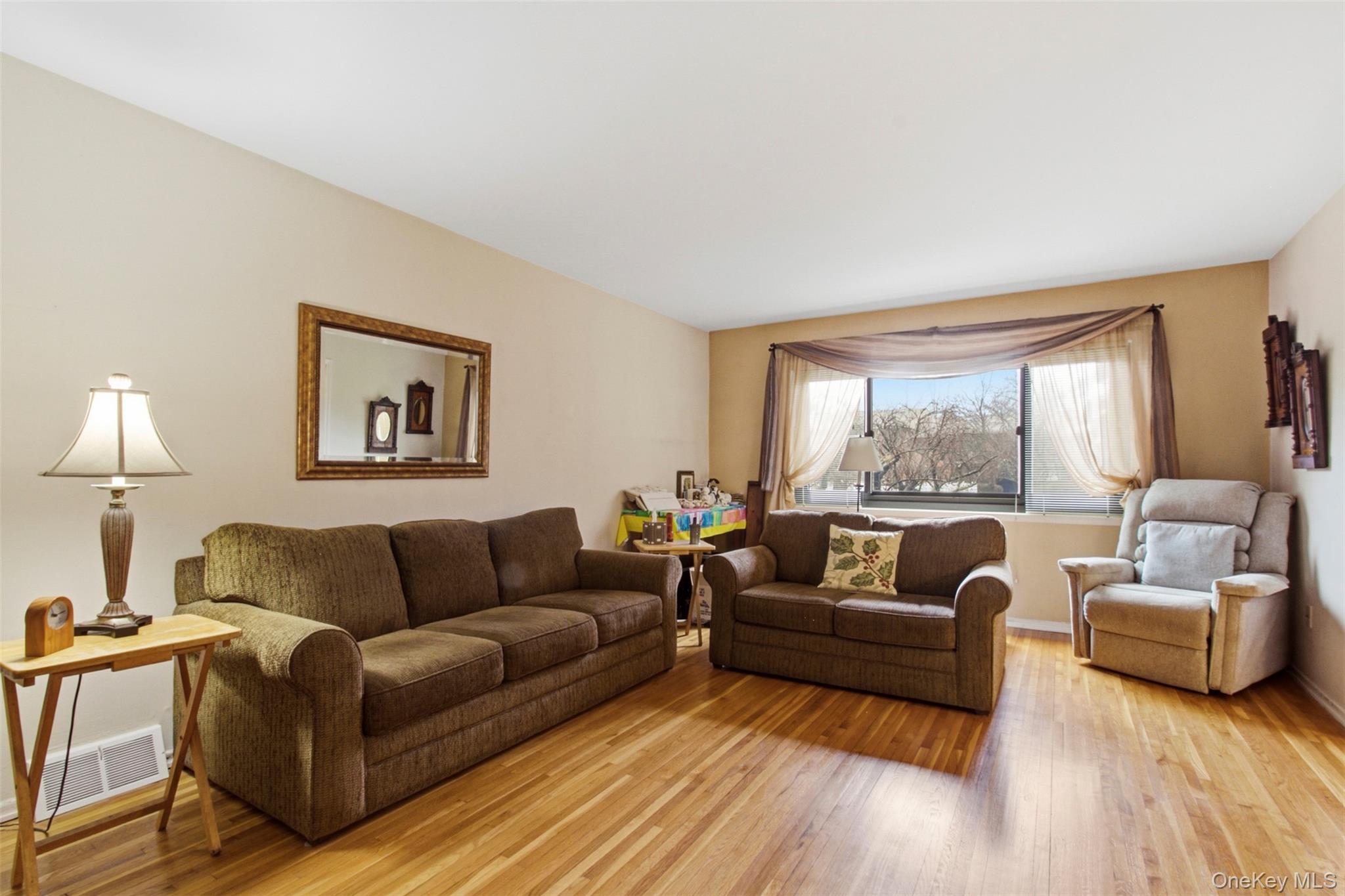 100 Gateway Road, Unit 192N Yonkers, NY 10703 - Photo 3 of 16 a living room with furniture and a large window