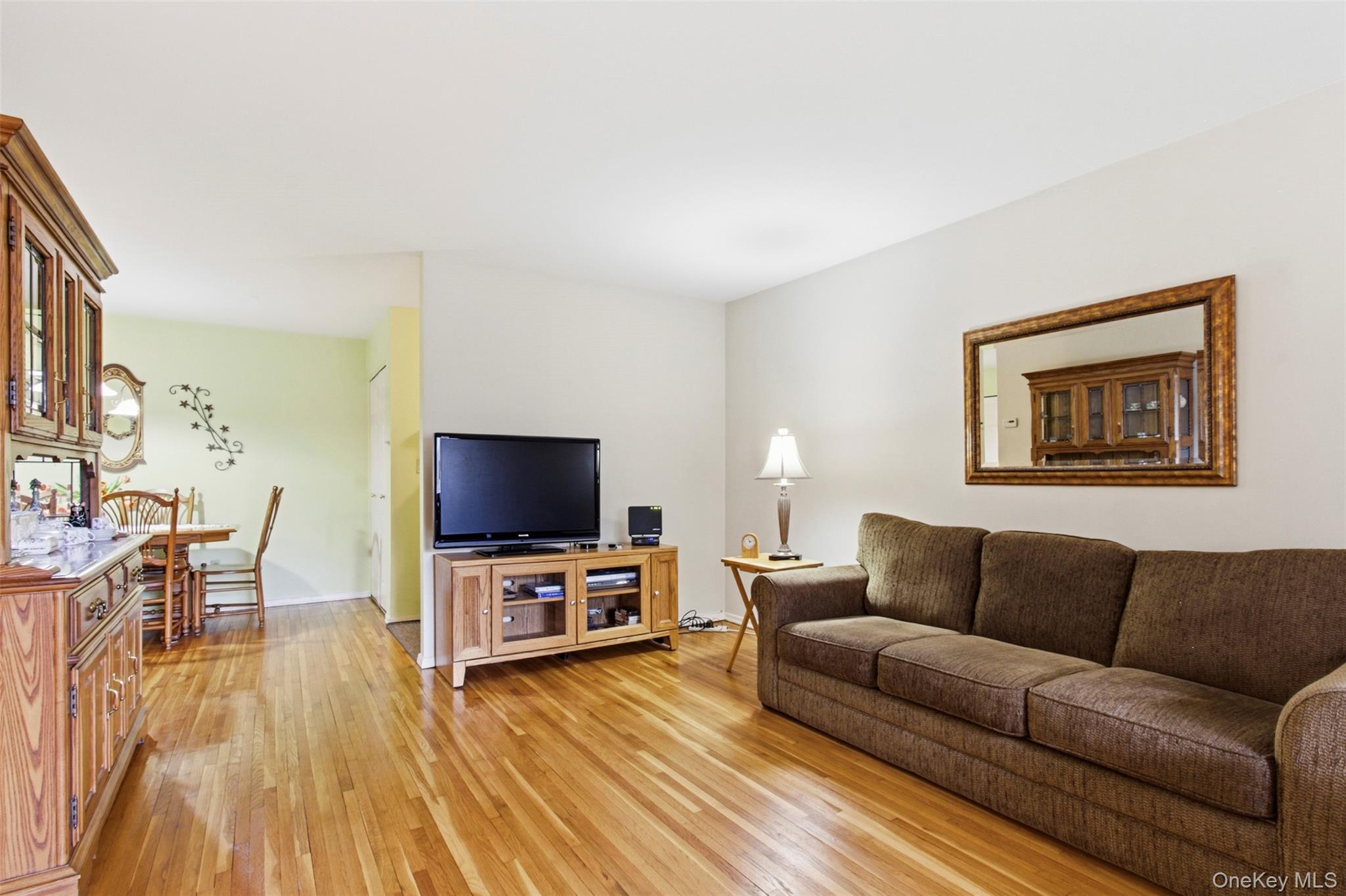 100 Gateway Road, Unit 192N Yonkers, NY 10703 - Photo 4 of 16 a living room with furniture and a flat screen tv
