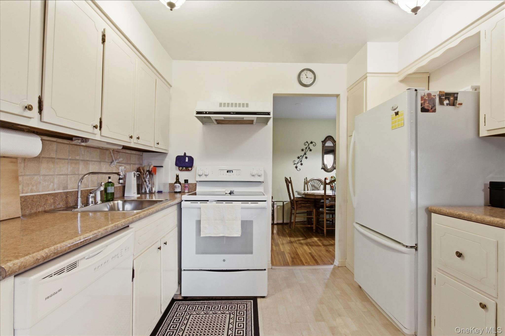 100 Gateway Road, Unit 192N Yonkers, NY 10703 - Photo 9 of 16 a kitchen with a white cabinets and white appliances